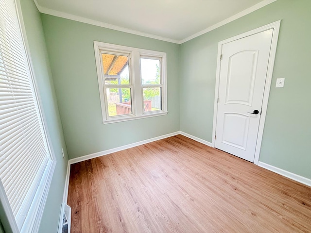 1327 N Pleasant Dr, Round Lake Beach, IL 60073 - unfurnished room with wood finished floors, baseboards, and ornamental molding