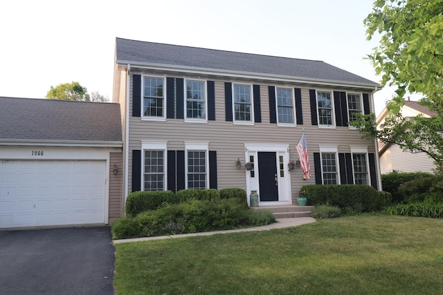1900 Waverly Ln, Algonquin, IL 60102 - colonial-style house featuring a front lawn, a garage, and asphalt driveway