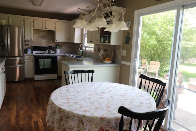 1900 Waverly Ln, Algonquin, IL 60102 - kitchen featuring white stove, stainless steel fridge with ice dispenser, a sink, light countertops, and decorative backsplash