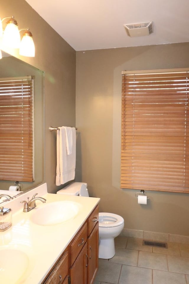 1900 Waverly Ln, Algonquin, IL 60102 - bathroom featuring toilet, double vanity, tile patterned floors, and baseboards