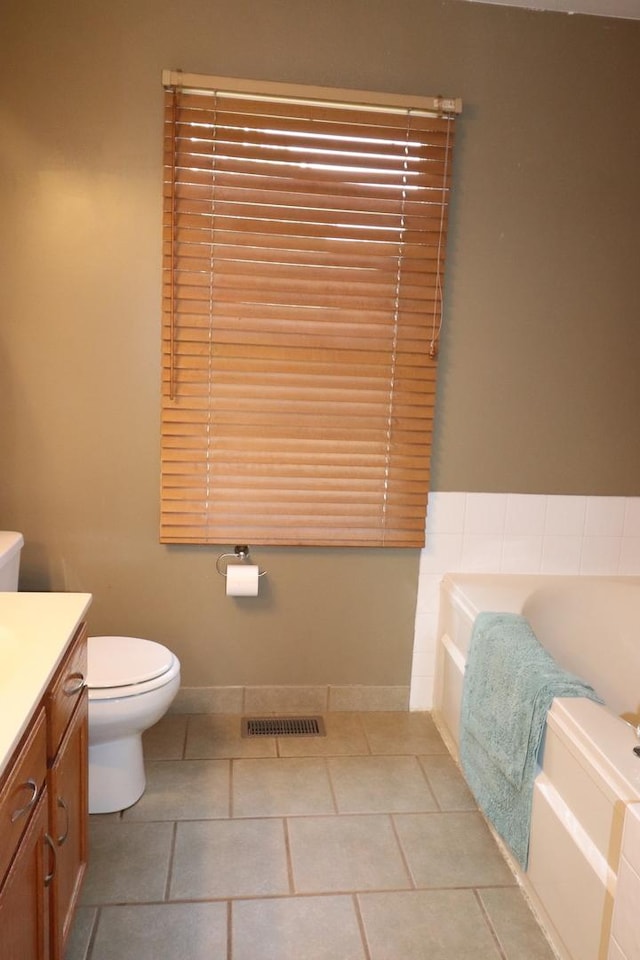 1900 Waverly Ln, Algonquin, IL 60102 - full bathroom featuring vanity, a garden tub, toilet, tile patterned flooring, and baseboards