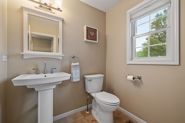 3502 Lake Side Cir, Joliet, IL 60431 - half bath featuring toilet, baseboards, and tile patterned floors