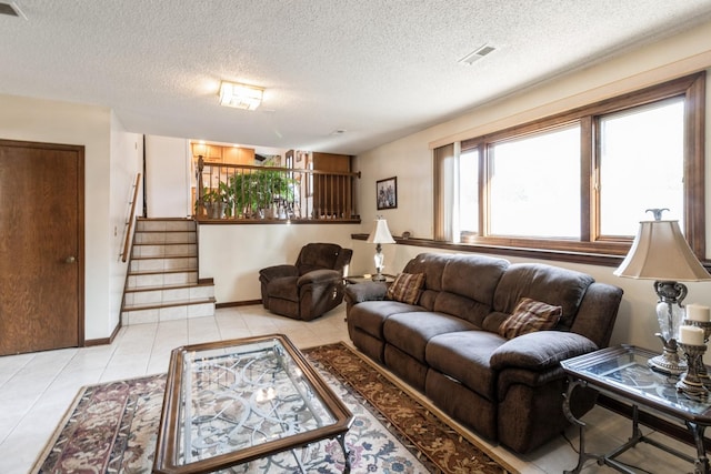 1243 W Byron Ave, Addison, IL 60101 - living room with a textured ceiling, stairway, and light tile patterned floors