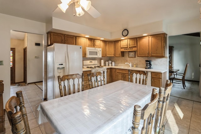 1243 W Byron Ave, Addison, IL 60101 - kitchen with white appliances, a ceiling fan, light tile patterned floors, tasteful backsplash, and light countertops