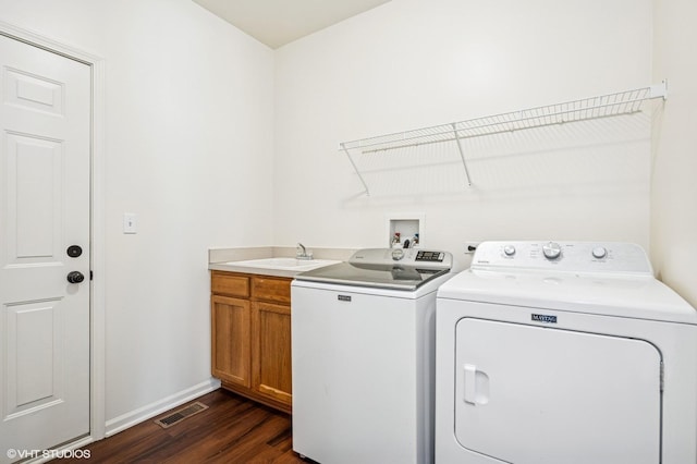 955 S Roxbury Ct, Round Lake, IL 60073 - laundry room with washing machine and clothes dryer, dark wood-style floors, and cabinet space