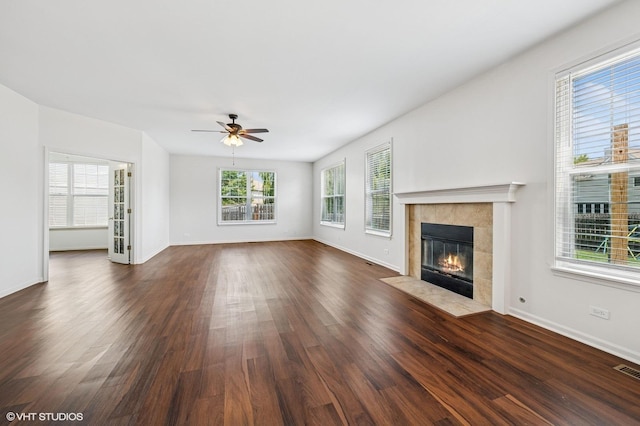955 S Roxbury Ct, Round Lake, IL 60073 - unfurnished living room featuring a tile fireplace, dark wood-type flooring, and a ceiling fan