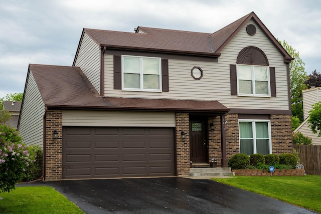 1413 N Metropolitan Ave, Waukegan, IL 60085 - view of front of house with brick siding, driveway, a shingled roof, and a garage