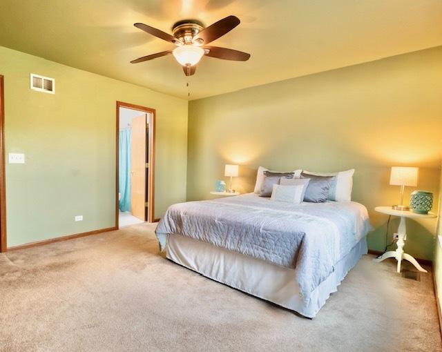 1413 N Metropolitan Ave, Waukegan, IL 60085 - bedroom with light colored carpet, baseboards, and ceiling fan