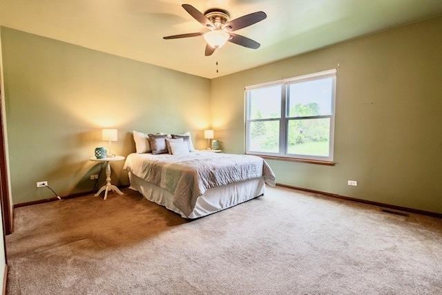 1413 N Metropolitan Ave, Waukegan, IL 60085 - carpeted bedroom with baseboards and ceiling fan
