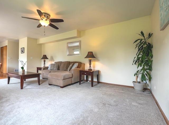 1413 N Metropolitan Ave, Waukegan, IL 60085 - living area with carpet, ceiling fan, and baseboards