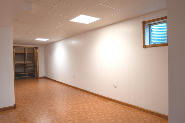 1413 N Metropolitan Ave, Waukegan, IL 60085 - spare room featuring a drop ceiling, light floors, and baseboards