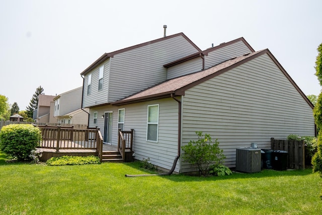 1413 N Metropolitan Ave, Waukegan, IL 60085 - rear view of property with a deck, central AC, and a lawn