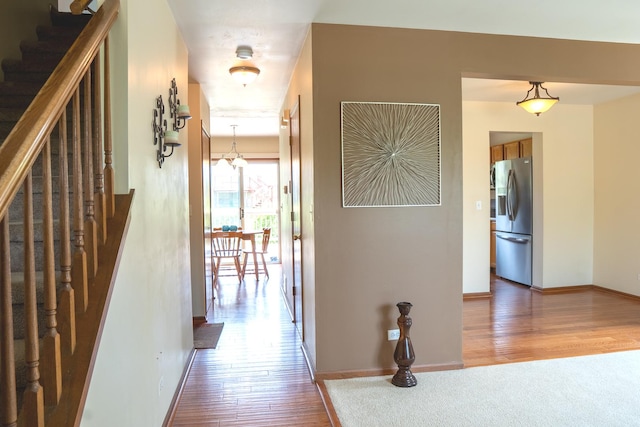 1413 N Metropolitan Ave, Waukegan, IL 60085 - corridor featuring wood finished floors, stairway, and baseboards