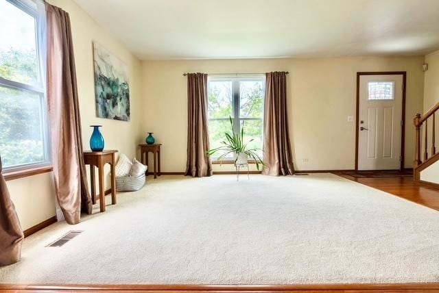1413 N Metropolitan Ave, Waukegan, IL 60085 - sitting room with stairway, healthy amount of natural light, baseboards, and carpet flooring