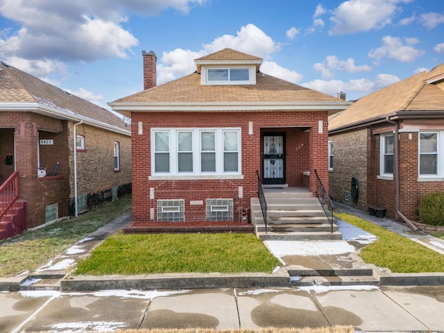 8418 S Ada St, Chicago, IL 60620 - bungalow-style house with brick siding, a chimney, a shingled roof, and a front yard