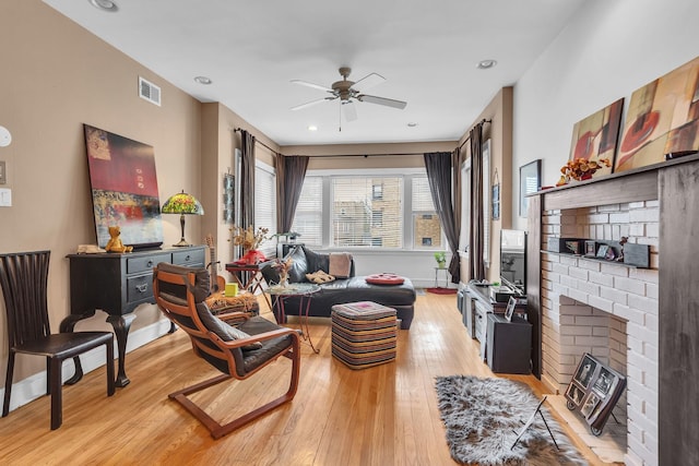 6210 N Francisco Ave, Chicago, IL 60659 - living room featuring light wood-style flooring, ceiling fan, baseboards, and a fireplace