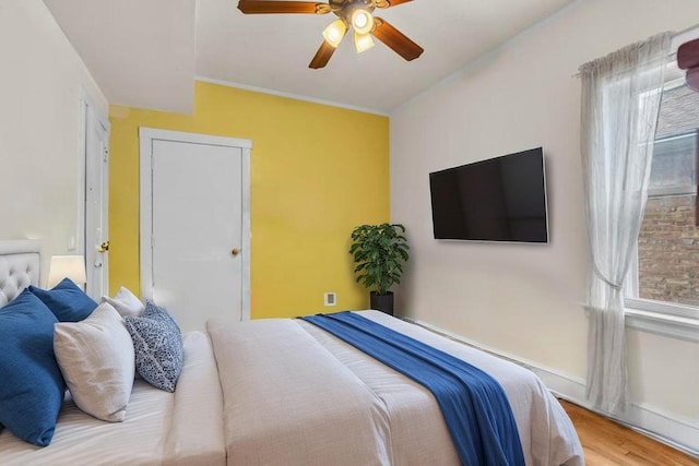 6210 N Francisco Ave, Chicago, IL 60659 - bedroom featuring multiple windows, wood finished floors, a ceiling fan, and baseboards