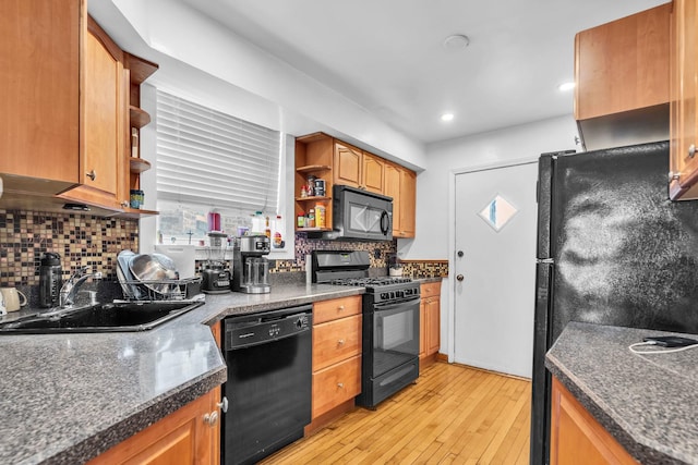 6210 N Francisco Ave, Chicago, IL 60659 - kitchen with black appliances, open shelves, a sink, light wood-type flooring, and backsplash