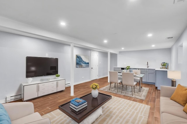 6210 N Francisco Ave, Chicago, IL 60659 - living area featuring light wood finished floors, recessed lighting, baseboards, and a baseboard heating unit