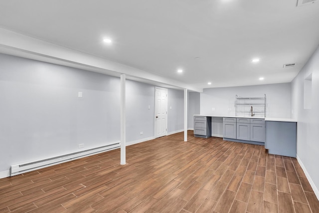 6210 N Francisco Ave, Chicago, IL 60659 - finished below grade area featuring a baseboard heating unit, baseboards, wood finished floors, and recessed lighting