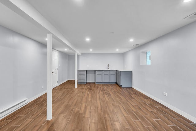 6210 N Francisco Ave, Chicago, IL 60659 - basement featuring a baseboard heating unit, wood finished floors, recessed lighting, and baseboards