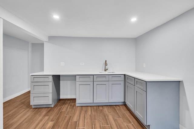 6210 N Francisco Ave, Chicago, IL 60659 - kitchen featuring a sink, gray cabinetry, light wood finished floors, light countertops, and recessed lighting