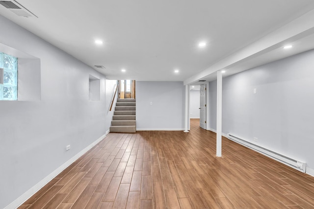 6210 N Francisco Ave, Chicago, IL 60659 - basement featuring baseboard heating, wood finished floors, recessed lighting, baseboards, and stairway