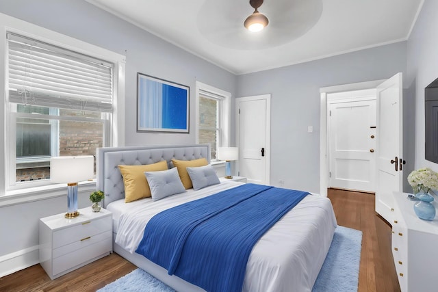 6210 N Francisco Ave, Chicago, IL 60659 - bedroom featuring multiple windows, wood finished floors, ornamental molding, and a ceiling fan