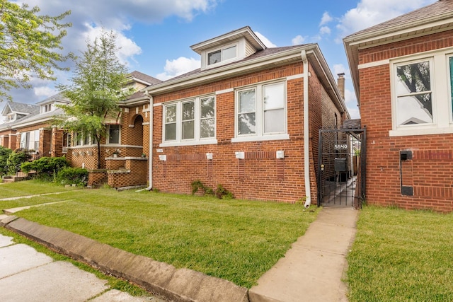 5544 S California Ave, Chicago, IL 60629 - bungalow featuring a gate, a front yard, and brick siding