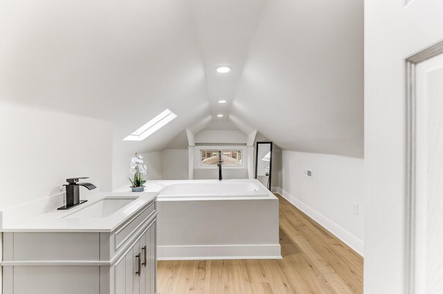 5544 S California Ave, Chicago, IL 60629 - additional living space featuring a sink, a skylight, lofted ceiling, light wood-type flooring, and recessed lighting