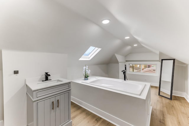 5544 S California Ave, Chicago, IL 60629 - bonus room with a skylight, recessed lighting, a sink, light wood-style floors, and vaulted ceiling