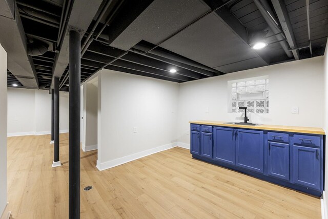 5544 S California Ave, Chicago, IL 60629 - finished below grade area with light wood-style floors, baseboards, and bar area