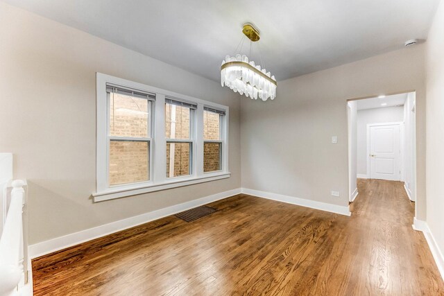 5544 S California Ave, Chicago, IL 60629 - empty room with wood finished floors, baseboards, a chandelier, and a smoke detector