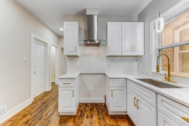 5544 S California Ave, Chicago, IL 60629 - kitchen with wall chimney range hood, a sink, white cabinetry, dark wood-style flooring, and light countertops