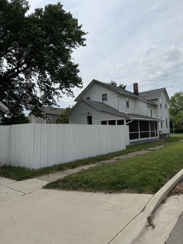 26 Elm Pl, Princeton, IL 61356 - view of home's exterior with a sunroom and a chimney