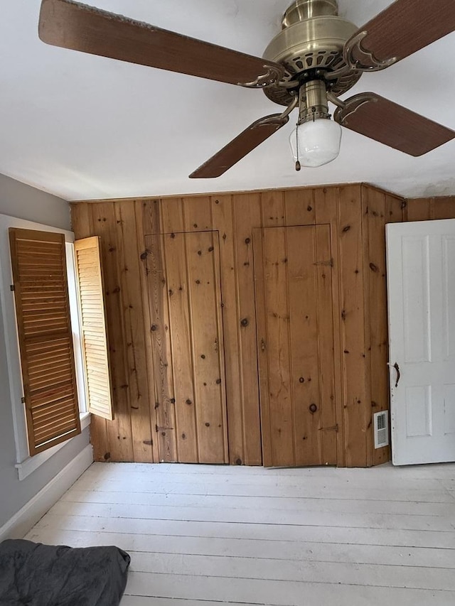 26 Elm Pl, Princeton, IL 61356 - detailed view of ceiling fan, wood finished floors, and wood walls