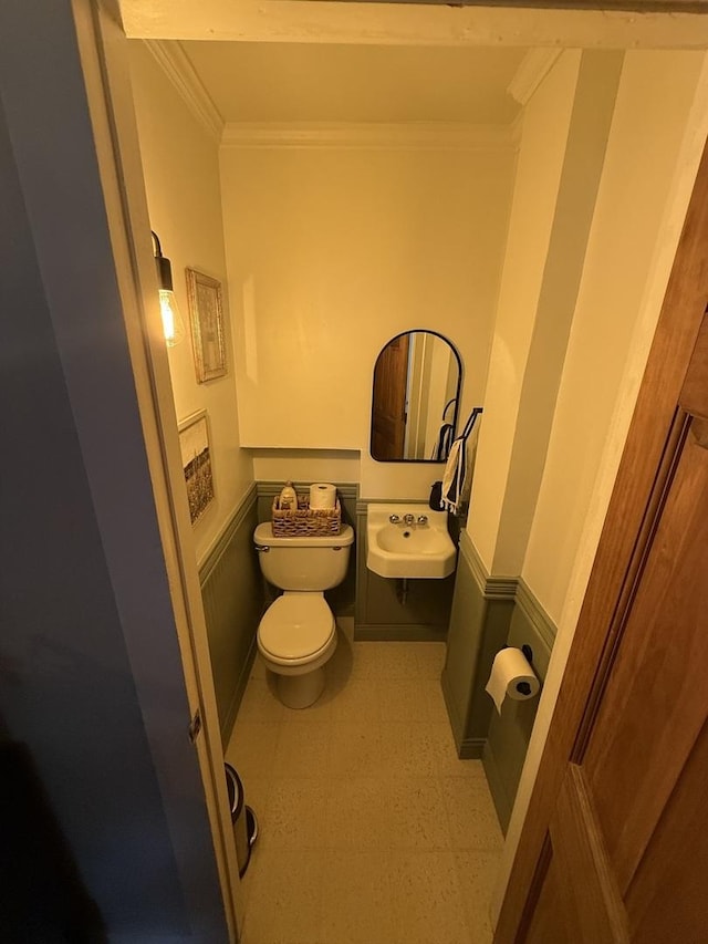 26 Elm Pl, Princeton, IL 61356 - half bath featuring crown molding, tile patterned floors, toilet, and a sink