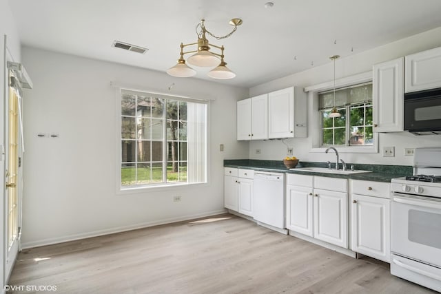 1727 W Hawkes St Unit 7, Arlington Heights, IL 60004 - kitchen with white appliances, a sink, dark countertops, and light wood finished floors