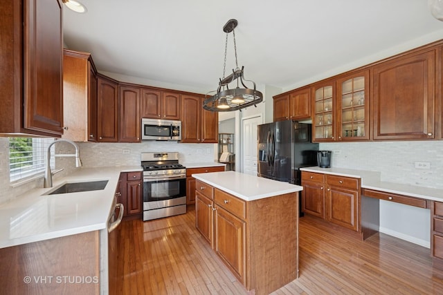 4370 Whitehall Ln, Algonquin, IL 60102 - kitchen featuring stainless steel appliances, light wood-type flooring, backsplash, and a center island