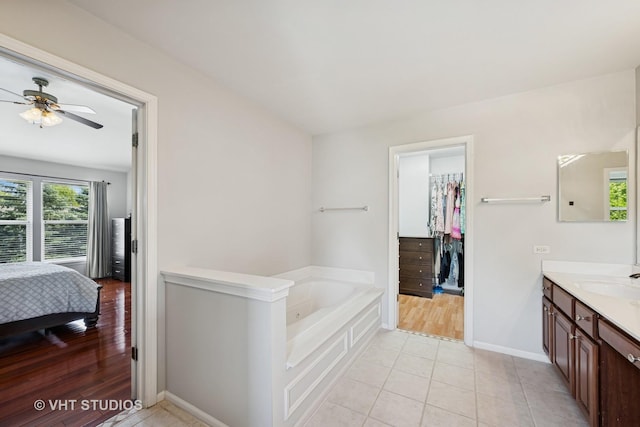 4370 Whitehall Ln, Algonquin, IL 60102 - full bath with vanity, a bath, ceiling fan, tile patterned flooring, and a spacious closet