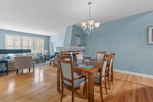 365 Lake Ave Unit D, Wauconda, IL 60084 - dining space with light wood finished floors, a chandelier, and baseboards