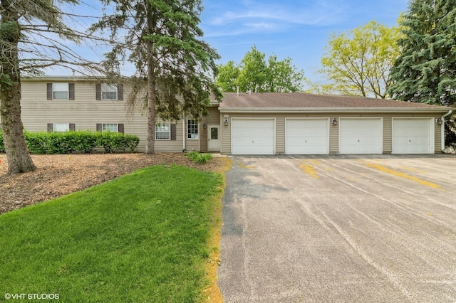 527 E Shagbark Ln Unit H, Streamwood, IL 60107 - view of front of home featuring asphalt driveway and a front lawn