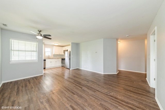 527 E Shagbark Ln Unit H, Streamwood, IL 60107 - unfurnished living room featuring dark wood finished floors and a ceiling fan