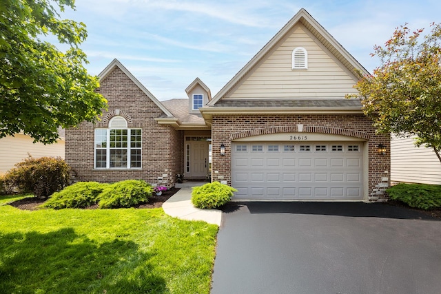 26615 W Captiva Ln, Plainfield, IL 60544 - traditional home with brick siding, driveway, a front yard, an attached garage, and roof with shingles