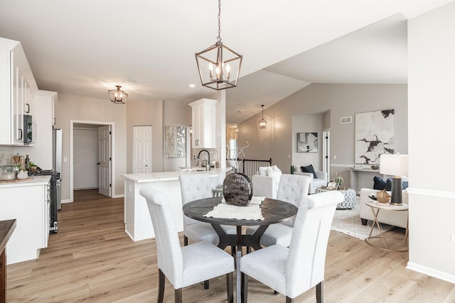 26615 W Captiva Ln, Plainfield, IL 60544 - dining space with a chandelier, light wood-style flooring, lofted ceiling, and baseboards