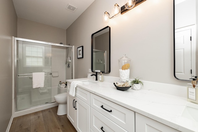 26615 W Captiva Ln, Plainfield, IL 60544 - full bathroom with toilet, double vanity, a stall shower, and wood finished floors