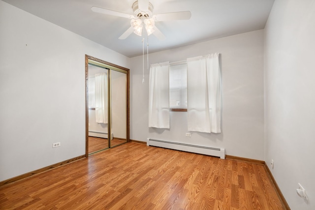 13116 Woodland Dr, Homer Glen, IL 60491 - unfurnished bedroom featuring a baseboard radiator, wood finished floors, baseboard heating, a closet, and ceiling fan