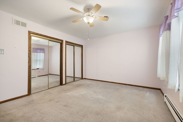 13116 Woodland Dr, Homer Glen, IL 60491 - unfurnished bedroom with baseboard heating, two closets, and carpet flooring