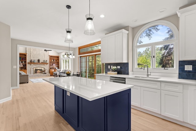 2731 Wolf River Ct, Naperville, IL 60565 - kitchen with a sink, a fireplace, tasteful backsplash, light countertops, and recessed lighting