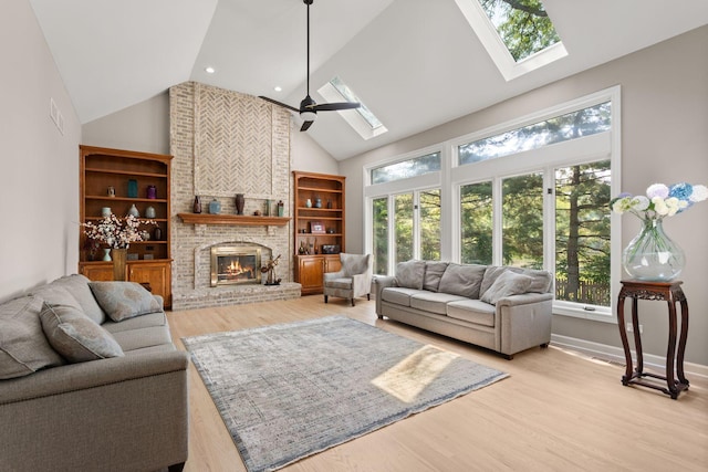 2731 Wolf River Ct, Naperville, IL 60565 - living room with a skylight, high vaulted ceiling, healthy amount of natural light, a brick fireplace, and light wood finished floors